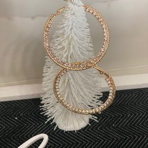 Gold tone and clear rhinestone hoop earrings.